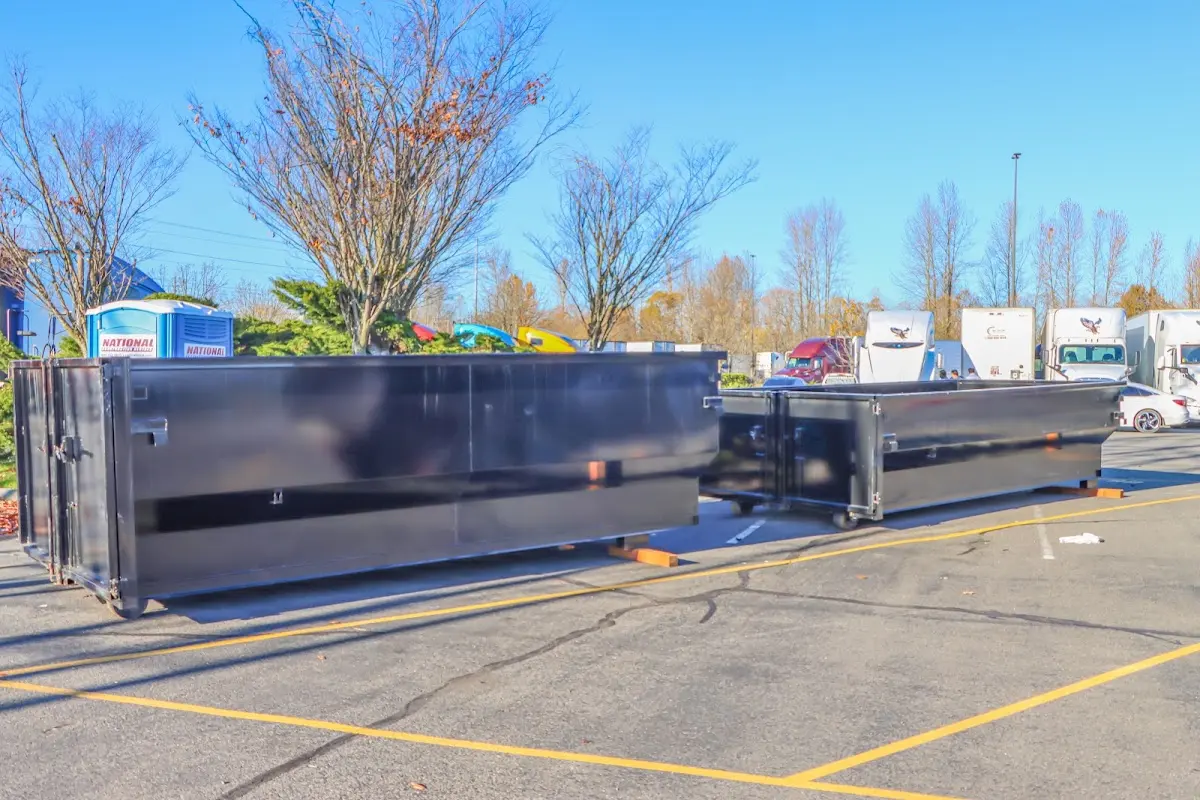 Professional dumpster rental service with roll-off container on residential driveway in Caddo Mills